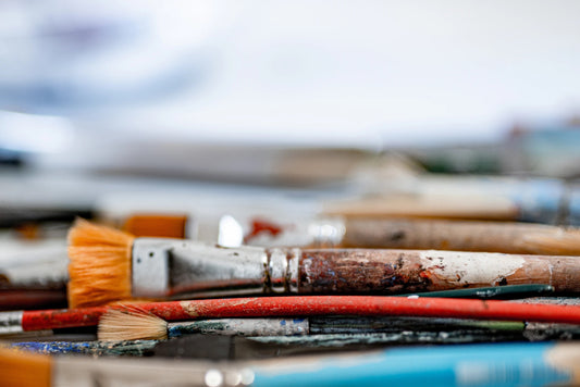 Close-up view of several paint brushes laying in a pile.